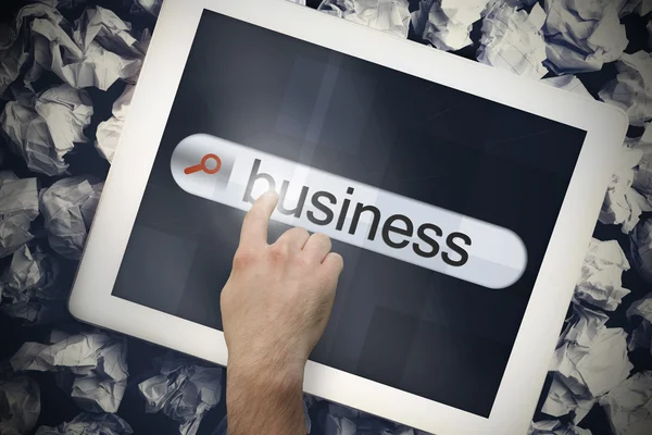 Hand touching business on search bar on tablet screen — Stock Photo, Image