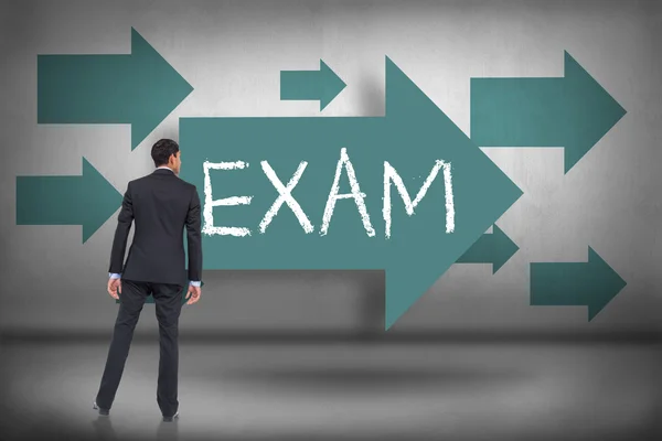 Exam - against blue arrows pointing — Stock Photo, Image