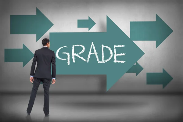 Grade - against blue arrows pointing — Stock Photo, Image