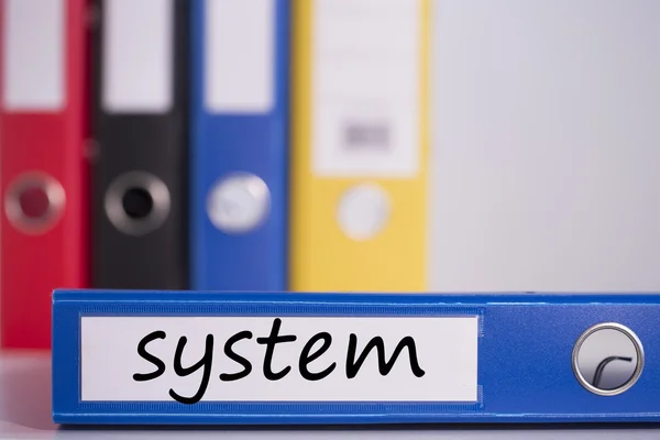 System on blue business binder — Stock Photo, Image