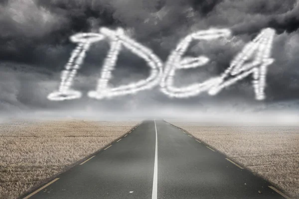 The word idea against road leading out to the horizon — Stock Photo, Image