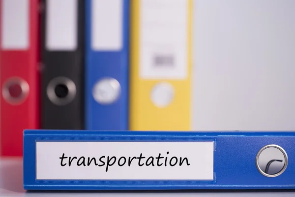 Transportation on blue business binder — Stock Photo, Image