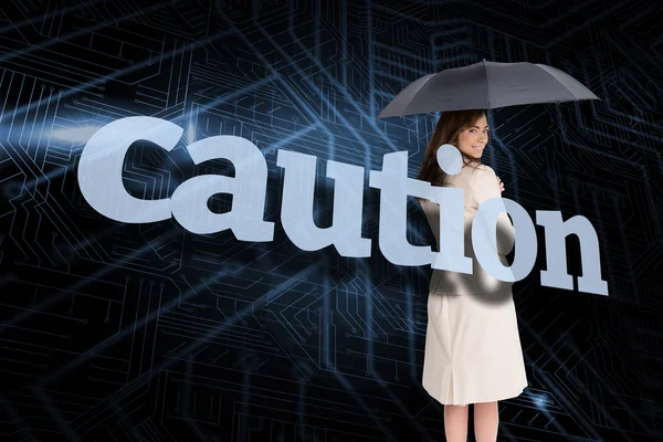 Businesswoman behind the word caution — Stock Photo, Image