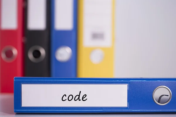 Code on blue business binder — Stock Photo, Image