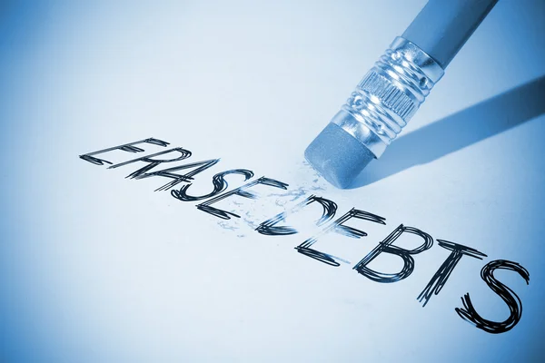 Pencil erasing the word Erase debts — Stock Photo, Image