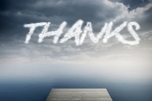 The word Thanks against cloudy sky over ocean — Stock Photo, Image