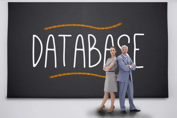 Business people standing against the word database — Stock Photo, Image