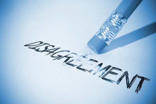 Pencil erasing the word Disagreement — Stock Photo, Image