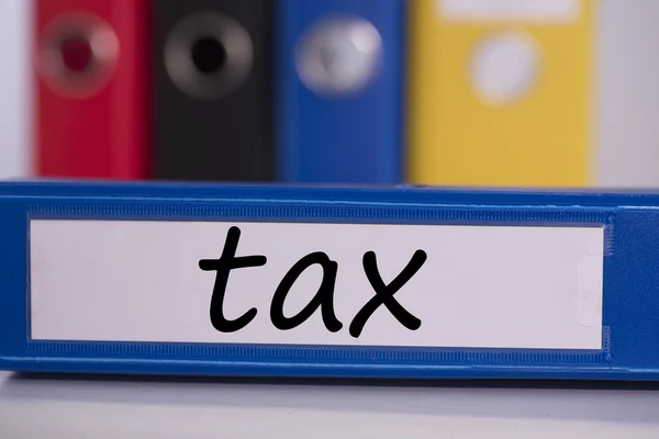 Tax on blue business binder — Stock Photo, Image