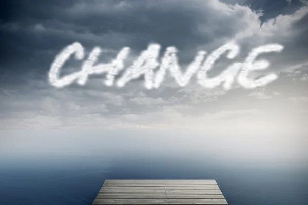 The word change against cloudy sky over ocean — Stock Photo, Image
