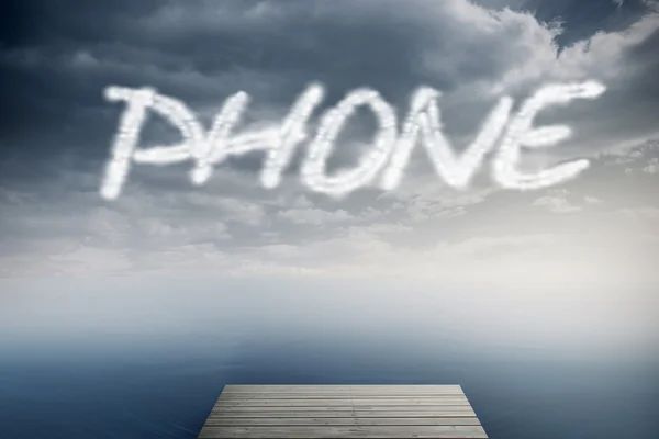 Het woord telefoon tegen bewolkte hemel over Oceaan — Stockfoto
