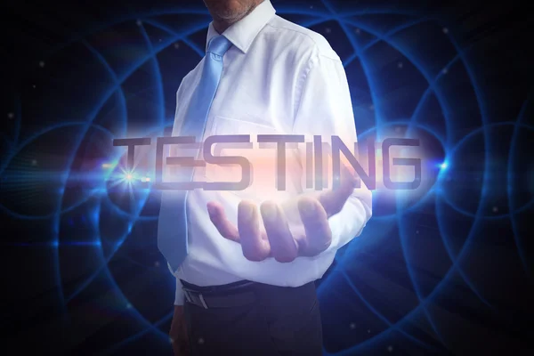 Businessman presenting the word testing — Stock Photo, Image