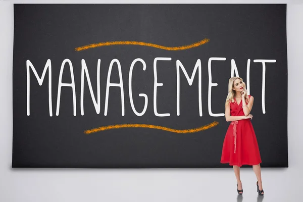 Pretty blonde thinking against the word management — Stock Photo, Image