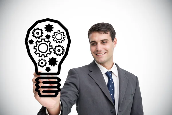 Businessman drawing light bulb — Stock Photo, Image