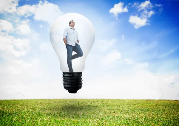 Thinking man in light bulb — Stock Photo, Image