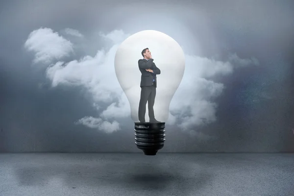 Thinking businessman in light bulb — Stock Photo, Image