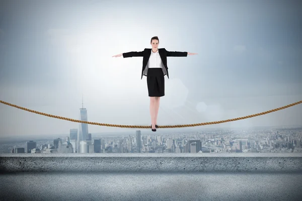 Businesswoman performing a balancing act — Stock Photo, Image