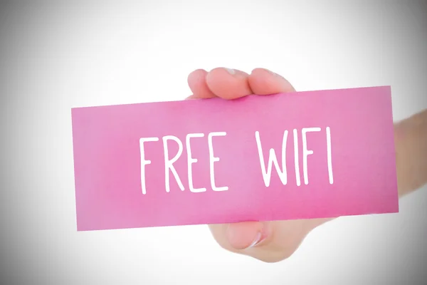 Woman holding pink card saying free wifi — Stock Photo, Image