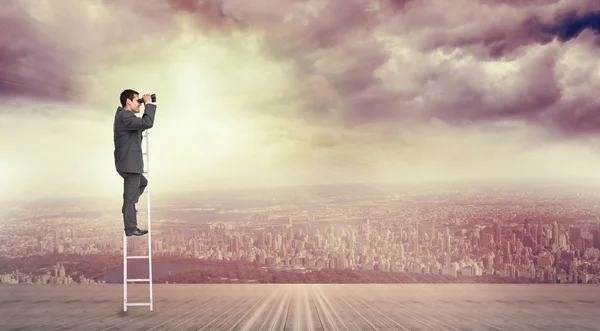 Businessman standing on ladder — Stock Photo, Image