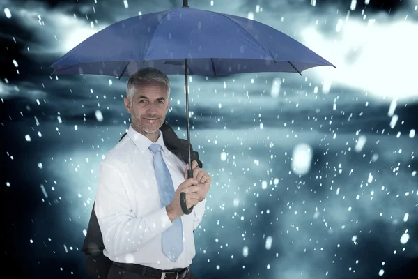 Businessman holding blue umbrella — Stock Photo, Image
