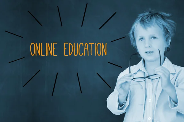 Online education against schoolboy and blackboard — Stock Photo, Image