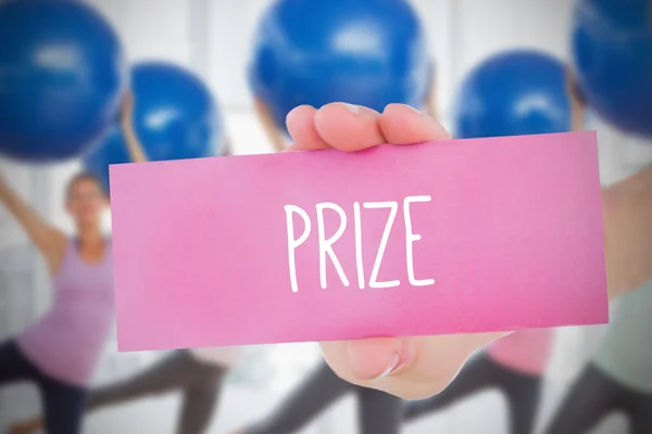 Woman holding pink card saying prize — Stock Photo, Image