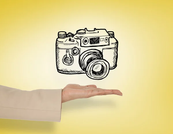 Female hand presenting camera doodle — Stock Photo, Image