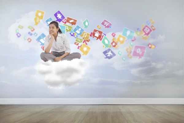 Businesswoman sitting cross legged thinking — Stock Photo, Image