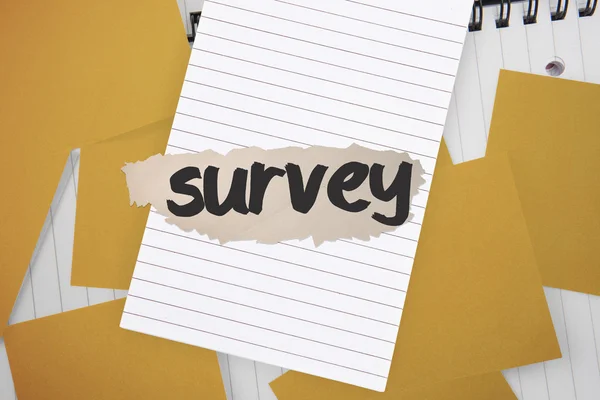 Survey against yellow paper strewn over notepad — Stock Photo, Image