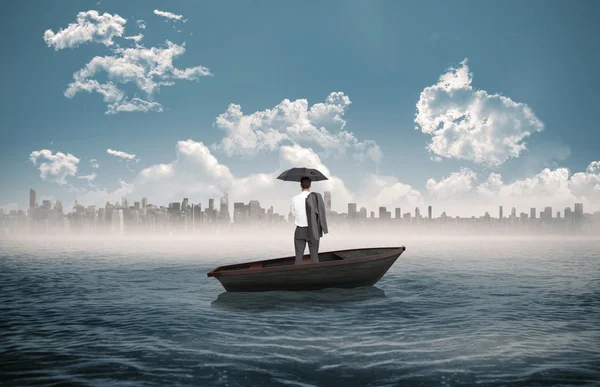 Businessman standing back to camera in a sailboat — Stock Photo, Image