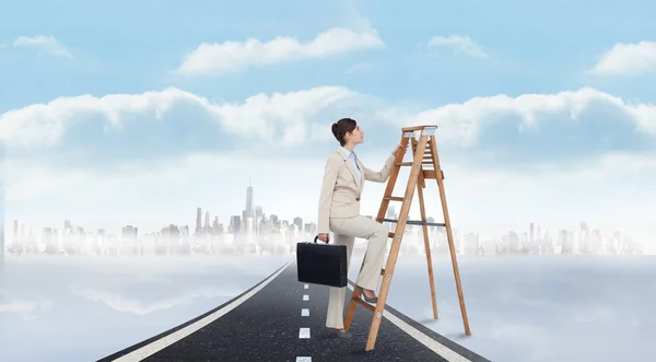 Businesswoman climbing career ladder — Stock Photo, Image