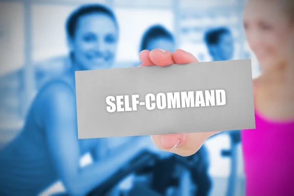 Fit blonde holding card saying self command — Stock Photo, Image