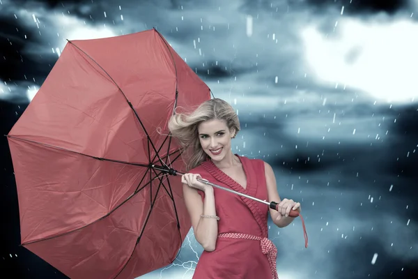 Smiling blonde holding umbrella — Stock Photo, Image