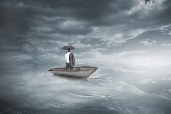 Businessman standing back to camera in a sailboat — Stock Photo, Image