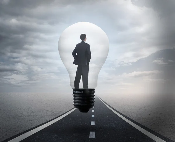 Thinking businessman in light bulb — Stock Photo, Image