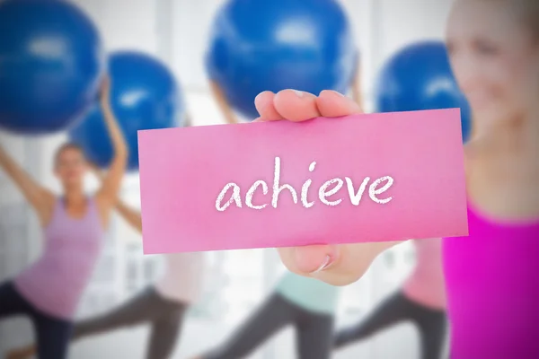 Woman holding pink card saying achive — Stock Photo, Image