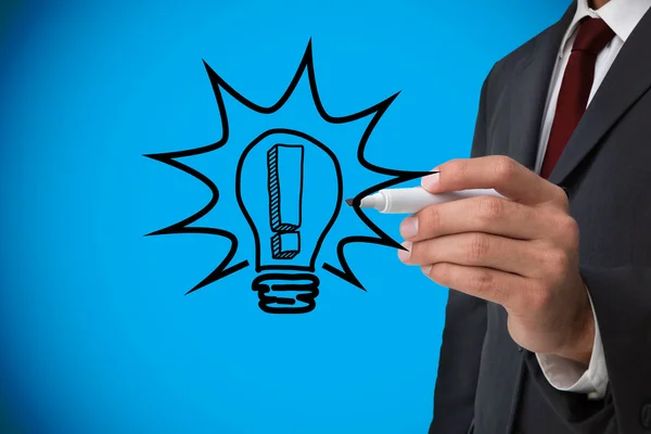 Businessman drawing light bulb — Stock Photo, Image