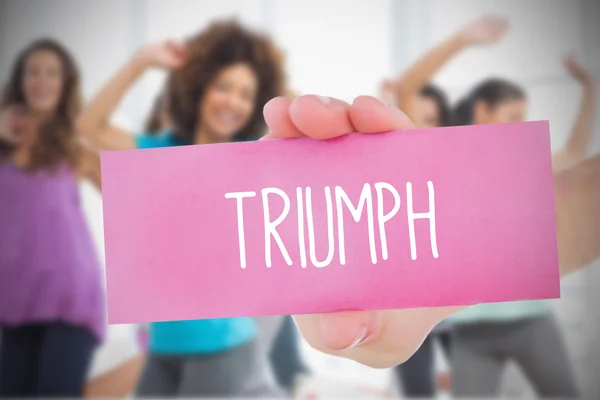 Woman holding pink card saying triumph — Stock Photo, Image