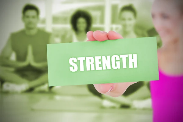 Fit blonde holding card saying strength — Stock Photo, Image