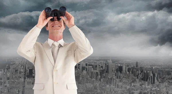Confident businessman with binoculars — Stock Photo, Image