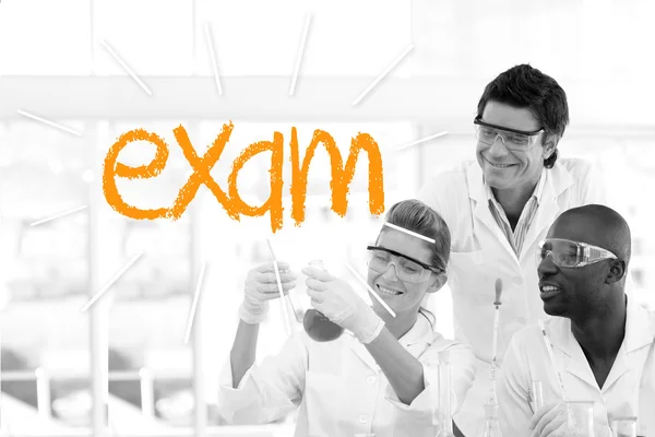 Exam against scientists working in laboratory — Stock Photo, Image