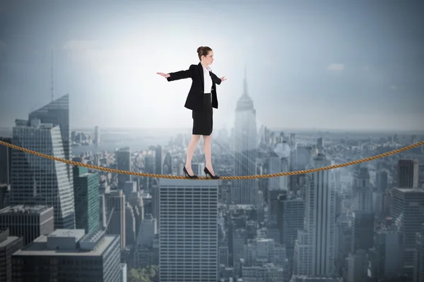 Businesswoman performing a balancing act — Stock Photo, Image