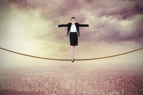 Businesswoman performing a balancing act — Stock Photo, Image
