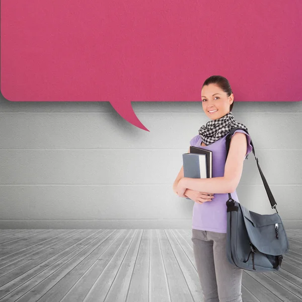 Student holding books and bag — Stock Photo, Image