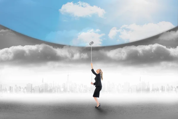 Businesswoman pulling down blue sky — Stock Photo, Image