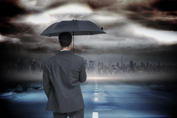 Classy businessman holding grey umbrella — Stock Photo, Image