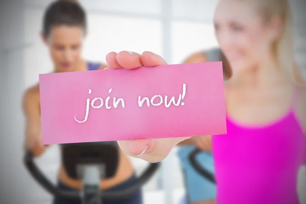 Fit blonde holding card saying join now — Stock Photo, Image