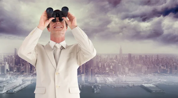 Businessman with binoculars — Stock Photo, Image