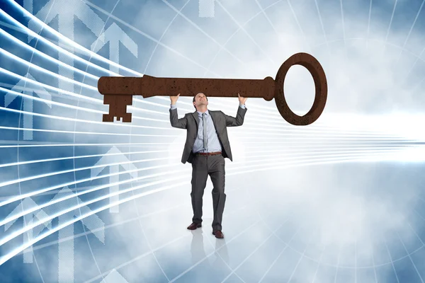 Businessman carrying large key — Stock Photo, Image