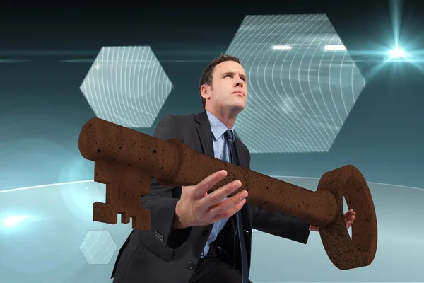 Businessman carrying large key — Stock Photo, Image